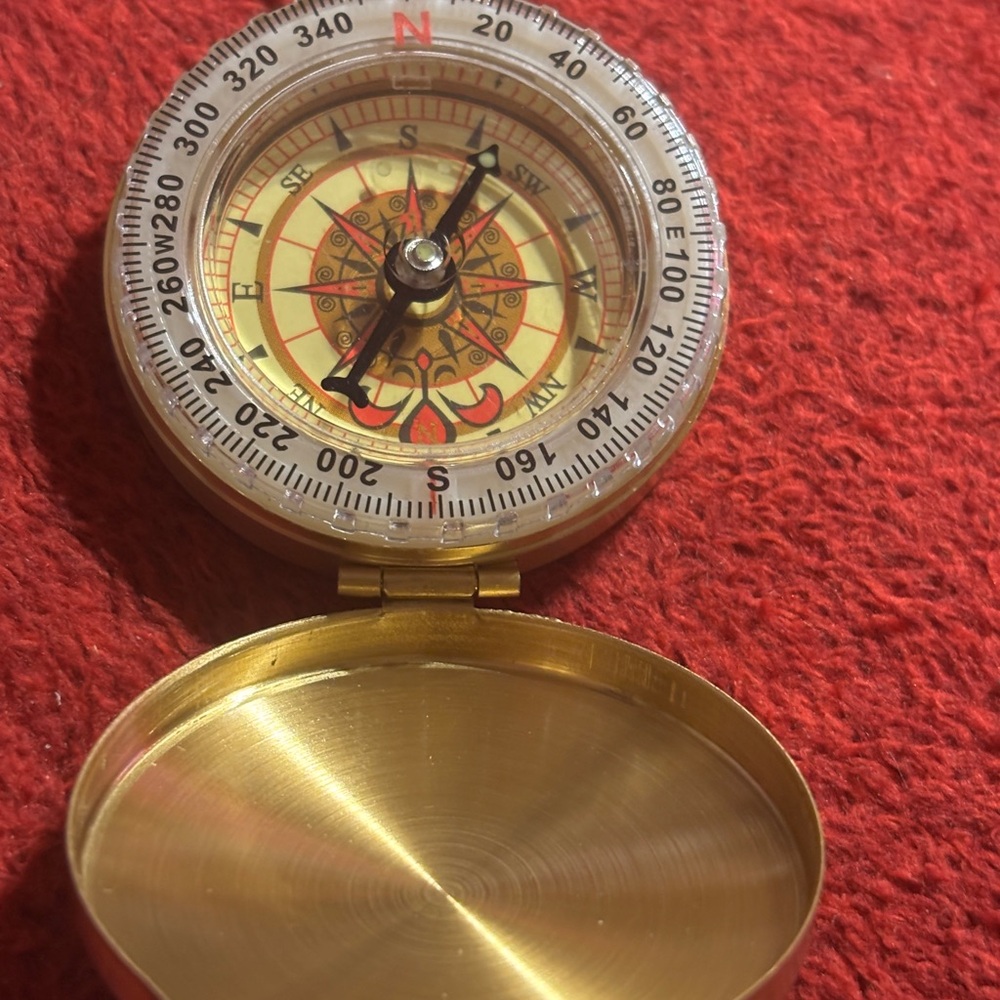 Brass Compass with Red and Gold Details.